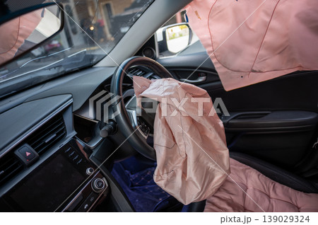 Deployed Airbags Inside Car Interior After Accident showing Steering Wheel and Dashboard Deployed Airbags Inside Car Interior After Accident showing Steering Wheel and Dashboard 139029324