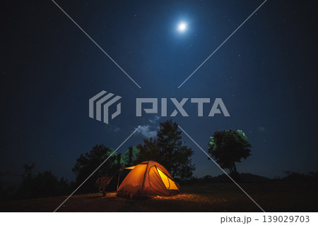 nature traveling with orange camping tent on mountain with milky way and star background 139029703