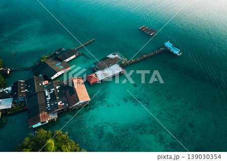 Aerial view of a traditional coastal village living in harmony with nature, showcasing sustainable living and slow life. 139030354