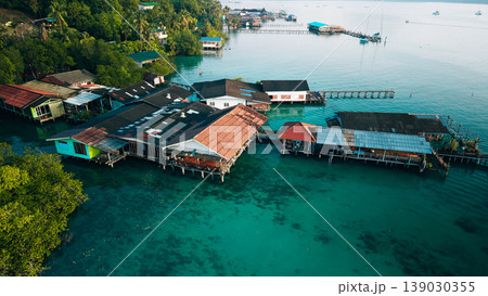 Aerial view of a traditional coastal village living in harmony with nature, showcasing sustainable living and slow life. Aerial view of a traditional coastal village living in harmony with nature, showcasing sustainable living and slow life. 139030355
