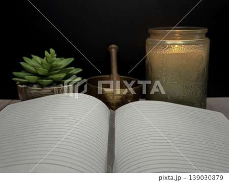 Open Book with Singing Bowl Candle and Succulent Plant for Meditation Spiritual Reflection Mindfulness Practice Wellness Concept Calm Healing Environment Holistic Self Care and Inner Peace Scene 139030879