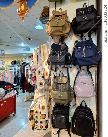 Yogyakarta, Indonesia - March 18th 2026: Diverse collection of modern backpacks and unique handmade crochet tote bags showcased in a vibrant retail store setting. Yogyakarta, Indonesia - March 18th 2026: Diverse collection of modern backpacks and unique handmade crochet tote bags showcased in a vibrant retail store setting. 139032224
