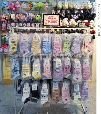 Yogyakarta, Indonesia - March 18th 2026: Vibrant retail display filled with packaged fashion socks, featuring diverse patterns, cartoon characters, and colors Yogyakarta, Indonesia - March 18th 2026: Vibrant retail display filled with packaged fashion socks, featuring diverse patterns, cartoon characters, and colors 139032225