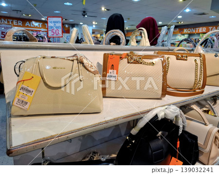 Yogyakarta, Indonesia - March 18th 2026: Close-up of stylish women's handbags and purses showcased on shelves in a vibrant retail store. 139032241