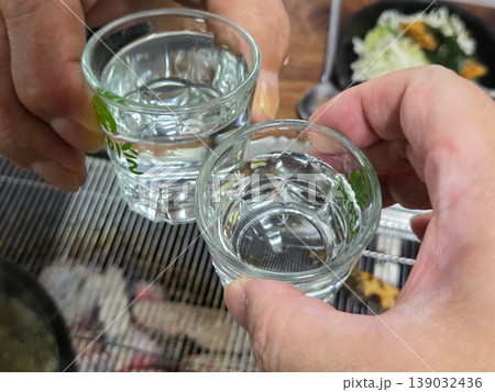clear korean distilled spirit soju in a small glass 139032436