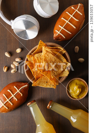 Snacks, drinks, and headphones are arranged on a table Snacks, drinks, and headphones are arranged on a table 139033057
