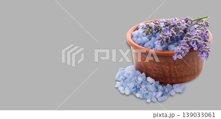 Bowl with blue bath salts and lavender flowers placed next to it Bowl with blue bath salts and lavender flowers placed next to it 139033061