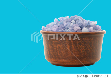 Lavender bath salts in a bowl with blue background Lavender bath salts in a bowl with blue background 139033081