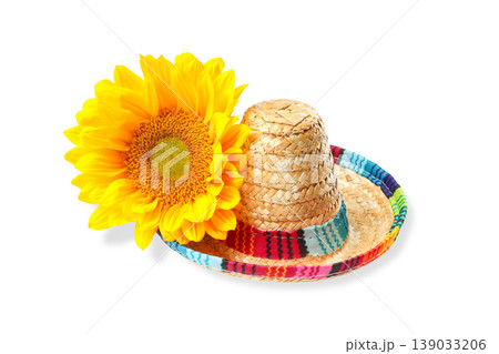 Colorful straw hat beside a sunflower, isolated, PNG 139033206