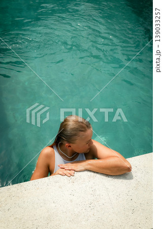 Person enjoys time in a pool surrounded by water Person enjoys time in a pool surrounded by water 139033257