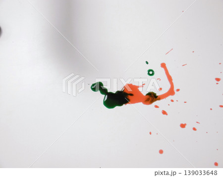 Green And Red Paints Blending Into Organic Shape Across White Background, Viscous Droplets And Delicate Trails Green And Red Paints Blending Into Organic Shape Across White Background, Viscous Droplets And Delicate Trails 139033648