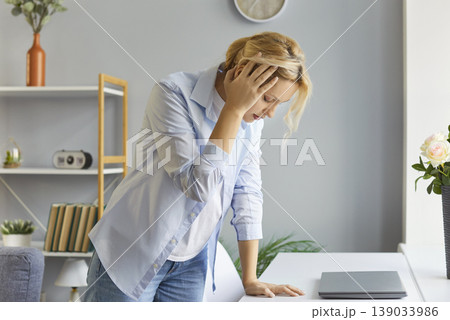 Stressed overworked woman suffering from terrible headache or dizziness Stressed overworked woman suffering from terrible headache or dizziness 139033986