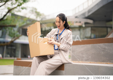 Successful business man, excited young woman packing up in office, job promotion concept, happy working. 139034302