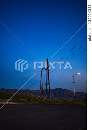 Night sky above utility poles on empty road Night sky above utility poles on empty road 139034331