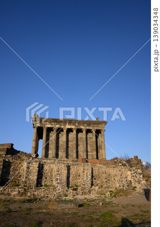 Sunlit Garni temple ruins on rocky terrain with no vegetation 139034348
