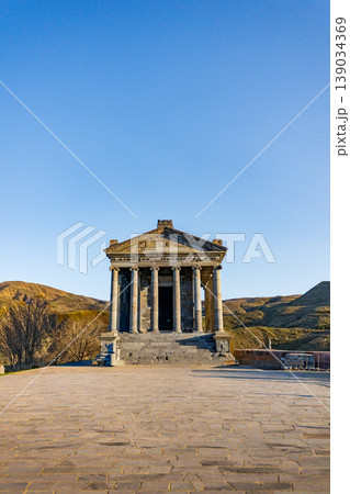 Stone temple with columns under sunny sky Stone temple with columns under sunny sky 139034369