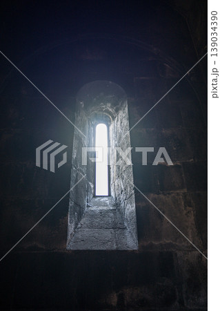 Narrow window in old stone wall Narrow window in old stone wall 139034390