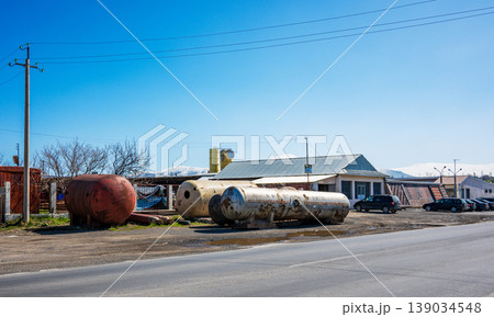 Rusty oil tanks near road in rural area Rusty oil tanks near road in rural area 139034548