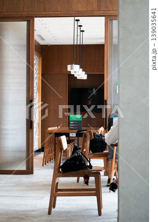 The community room in the coffee shop available for reservation. Co working space concept. The interior of meeting room in the cafe The community room in the coffee shop available for reservation. Co working space concept. The interior of meeting room in the cafe 139035641