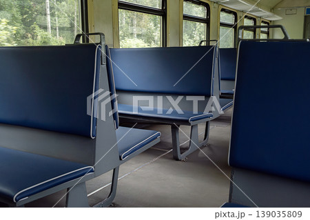 Empty passenger seats inside old railway carriage. Empty passenger seats inside old railway carriage. 139035809