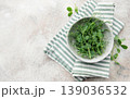 Fresh green pea shoots in bowl on towel 139036532