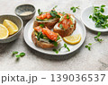 Salmon avocado toasts with microgreens and lemon 139036537