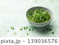 Fresh microgreens in a bowl on wooden surface 139036576