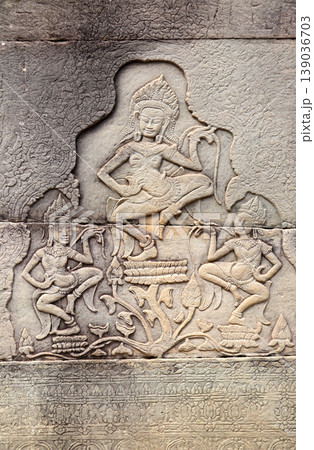 Wall carving with two womans dancers apsara, famous Angkor Wat complex, Siem Reap, Cambodia. Stone texture and bas-relief with dancing girls. Topic of vacation, travel, trip, cruises, tour Wall carving with two womans dancers apsara, famous Angkor Wat complex, Siem Reap, Cambodia. Stone texture and bas-relief with dancing girls. Topic of vacation, travel, trip, cruises, tour 139036703