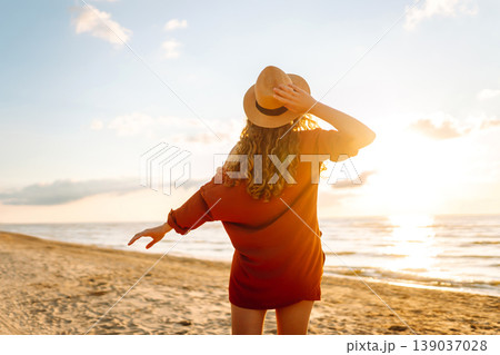 Beautiful woman enjoying a summer day on the beach at sunset. Lifestyle, tourism, active life. Beautiful woman enjoying a summer day on the beach at sunset. Lifestyle, tourism, active life. 139037028