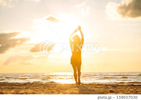 Beautiful woman enjoying a summer day on the beach at sunset. Lifestyle, tourism, active life. Beautiful woman enjoying a summer day on the beach at sunset. Lifestyle, tourism, active life. 139037030