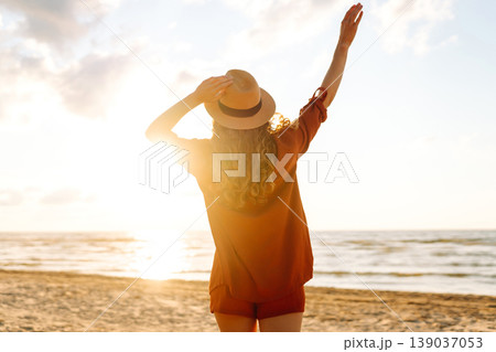 Beautiful woman enjoying a summer day on the beach at sunset. Lifestyle, tourism, active life. Beautiful woman enjoying a summer day on the beach at sunset. Lifestyle, tourism, active life. 139037053