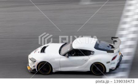 Motion blur, Race car racing on speed track, race car on road crossing start and finish line, Target business achieve and victory concept. . Motion blur, Race car racing on speed track, race car on road crossing start and finish line, Target business achieve and victory concept. . 139038473
