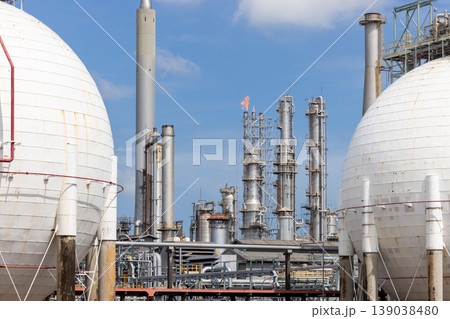 Industrial gas storage sphere tank at oil and gas refinery and petrochemical plant under blue sky, Oil and gas refinery plant and petrochemical industry infrastructure with gas storage tank pipeline. Industrial gas storage sphere tank at oil and gas refinery and petrochemical plant under blue sky, Oil and gas refinery plant and petrochemical industry infrastructure with gas storage tank pipeline. 139038480