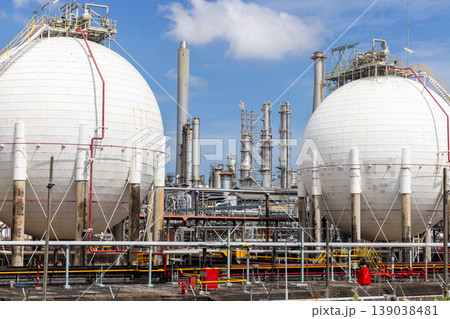 Industrial gas storage sphere tank at oil and gas refinery and petrochemical plant under blue sky, Oil and gas refinery plant and petrochemical industry infrastructure with gas storage tank pipeline. Industrial gas storage sphere tank at oil and gas refinery and petrochemical plant under blue sky, Oil and gas refinery plant and petrochemical industry infrastructure with gas storage tank pipeline. 139038481