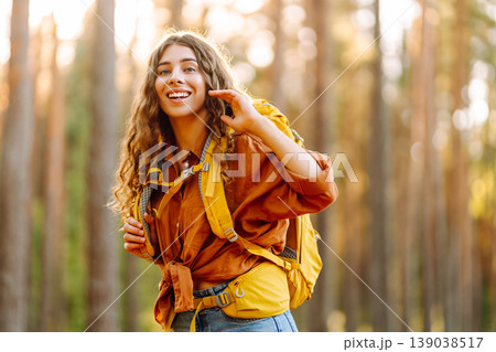 Stylish woman enjoying autumn weather in the park. Autumn mood. Hiking. Stylish woman enjoying autumn weather in the park. Autumn mood. Hiking. 139038517