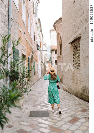 Happy woman walking in shopping street in Italy on vacation dressed in summer fashion dress. 139038637