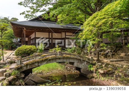 Zenno-ji Temple and stone bridge surrounded by greenery in Takayama 139039058