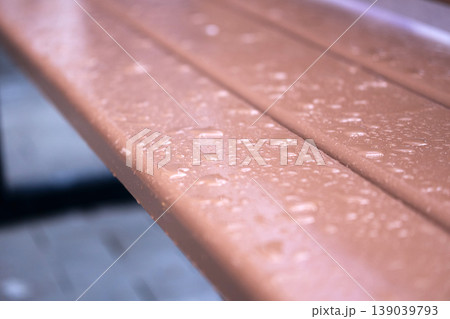 Rainwater collects on wooden bench after a storm in a park during early morning hours Rainwater collects on wooden bench after a storm in a park during early morning hours 139039793