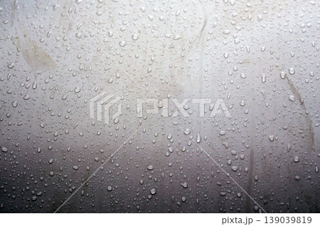 Water droplets gather on a flat surface showing details of size and shape Water droplets gather on a flat surface showing details of size and shape 139039819