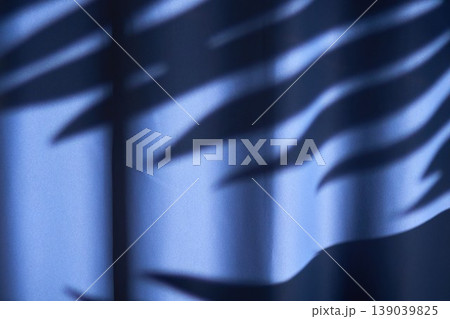 Soft ambient lighting shapes delicate fabric shadows. Vivid shadows cast by ambient light define textured fabric in dynamic visual effects Soft ambient lighting shapes delicate fabric shadows. Vivid shadows cast by ambient light define textured fabric in dynamic visual effects 139039825