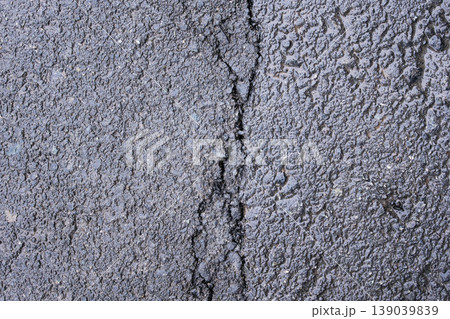 Asphalt texture with a deep crack, close-up top view, industrial background Asphalt texture with a deep crack, close-up top view, industrial background 139039839