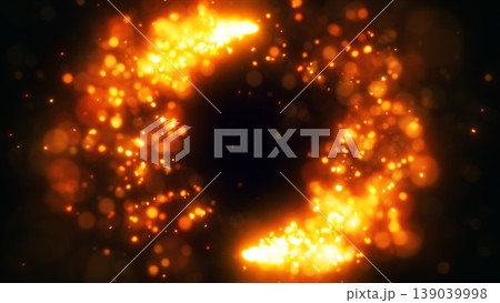 Hot orange and amber particle burst creating a glowing circular frame with bokeh sparks on dark background and empty copy space in the middle 139039998