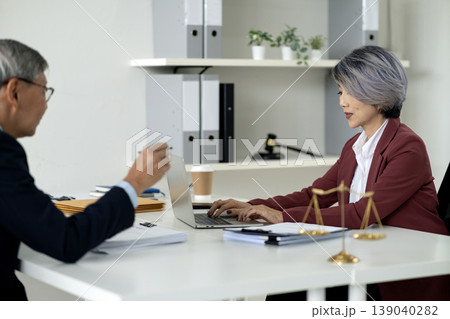 Asian adult legal professionals discuss important cases collaborate laptop modern law office consultation justice scales for business expertise Asian adult legal professionals discuss important cases collaborate laptop modern law office consultation justice scales for business expertise 139040282