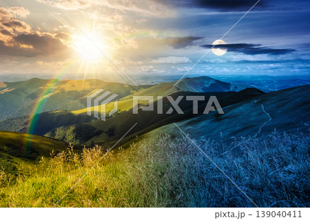 day meet night. mountain landscape with alpine meadow. sun and moon over carpathian mountain scenery on summer solstice. view in to the distant valley landscape. rolling hills and grassy meadow day meet night. mountain landscape with alpine meadow. sun and moon over carpathian mountain scenery on summer solstice. view in to the distant valley landscape. rolling hills and grassy meadow 139040411