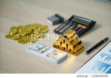 Financial professional assesses gold bars dollar bills investment management wealth growth business strategy 139040494
