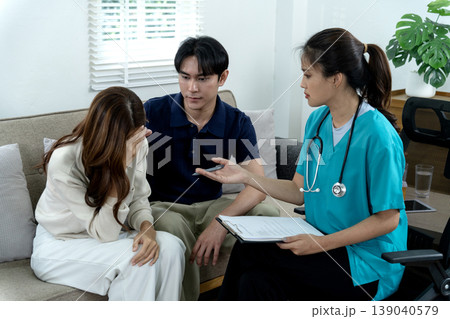 Asian adult couple distressed seek medical consultation empathetic female doctor provides mental health support relationship guidance at modern home environment 139040579