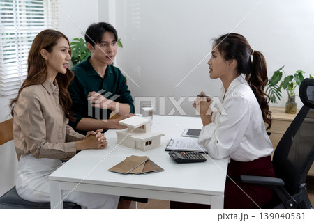 Asian adult clients meeting real estate professional discussing future home property investment consulting design plans material options 139040581
