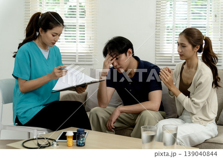 Asian medical professional provides mental health consultation adult man wife offers emotional support during therapy session in clinic 139040844