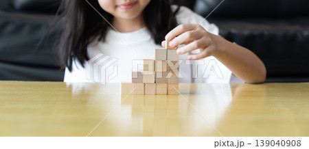 Wooden blocks rising steps child behind patience effort planning strategy step progress focus control consistency logical development achievement. Wooden blocks rising steps child behind patience effort planning strategy step progress focus control consistency logical development achievement. 139040908