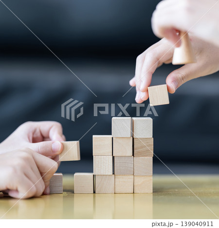 Wooden blocks rising steps child behind patience effort planning strategy step progress focus control consistency logical development achievement. 139040911
